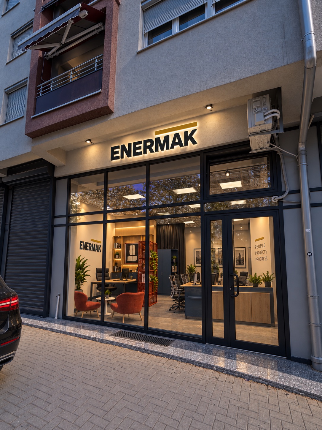 Street-level entrance to the Enermak office with an illuminated sign